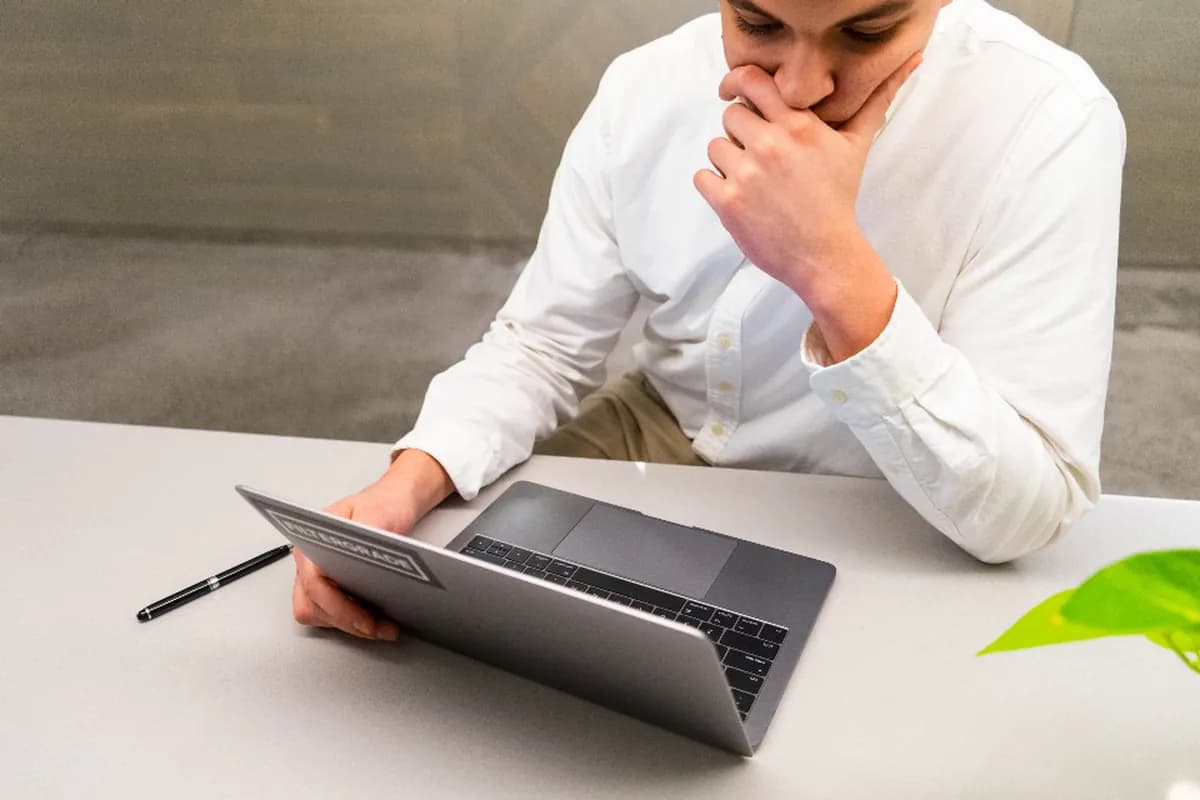 Illustrative photograph of a person considering work at a laptop; not an LFL customer.